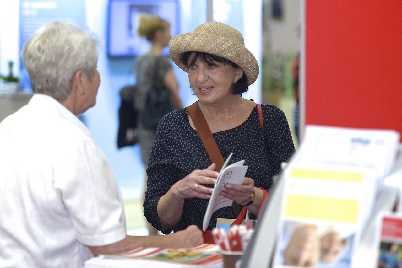 A woman standing at an exhibition stand