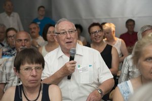 Man from the audience asking question during an event