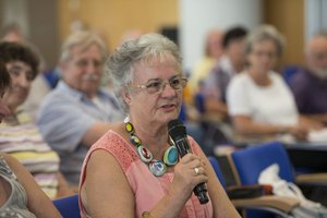 Women sitting in the audience and asking a question